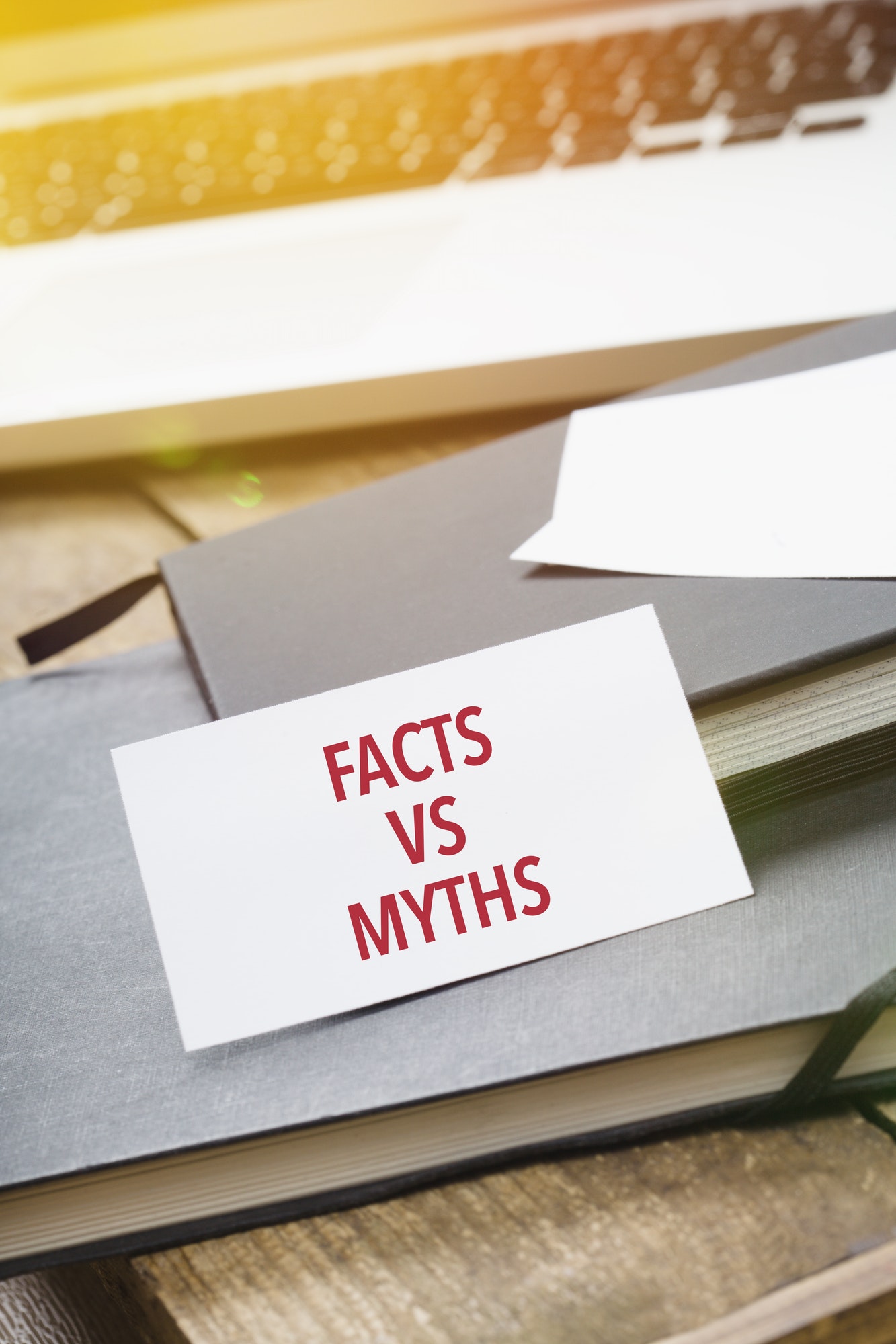 Facts vs Myths on card at office desktop